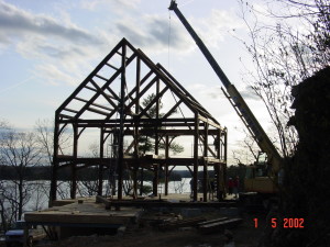 Timberframe being raised on a site.